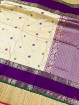 Semi kanjivaram soft silk woven saree. *Intricate weaving resham butties in body and contrast reshamwoven gap borders both sides and woven pallu with attached thread tassels.Pairswith *contrast woven blouse*