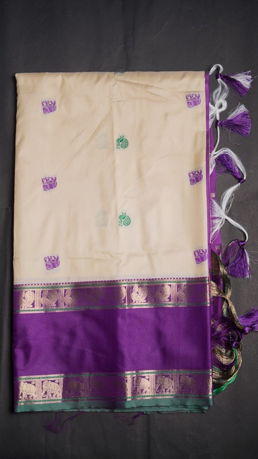 Semi kanjivaram soft silk woven saree. *Intricate weaving resham butties in body and contrast reshamwoven gap borders both sides and woven pallu with attached thread tassels.Pairswith *contrast woven blouse*