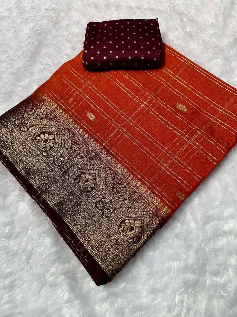 Kanjivaram silk saree with zari chex and contrast dyed zari borderComes with contrast dyed lining zari pallupaired with viscose silk blouse