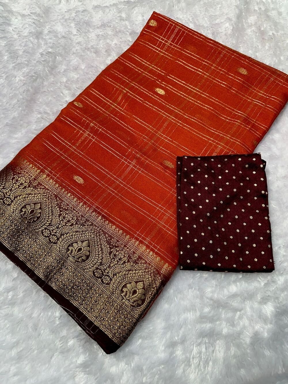 Kanjivaram silk saree with zari chex and contrast dyed zari borderComes with contrast dyed lining zari pallupaired with viscose silk blouse