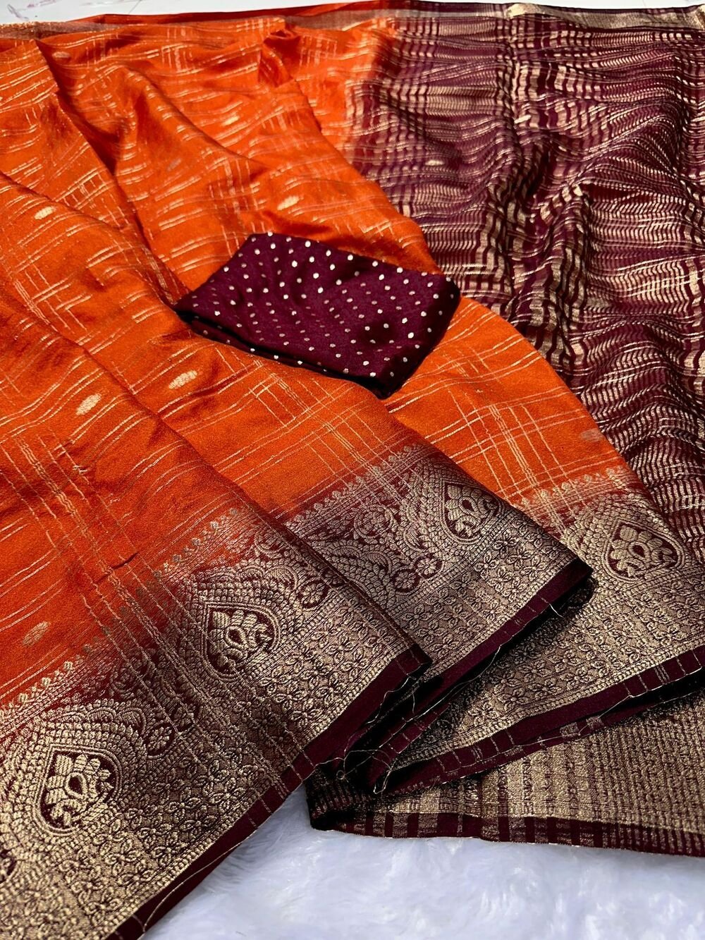 Kanjivaram silk saree with zari chex and contrast dyed zari borderComes with contrast dyed lining zari pallupaired with viscose silk blouse